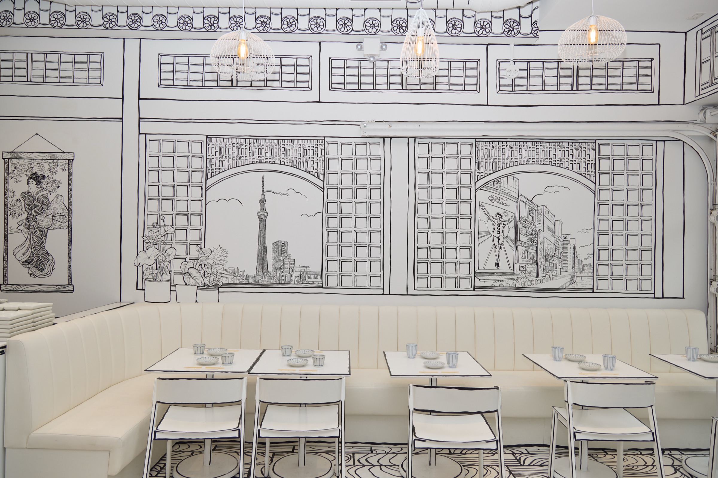 Shirokuro interior &mdash; hand-drawn black lines on white walls, looking toward the counter