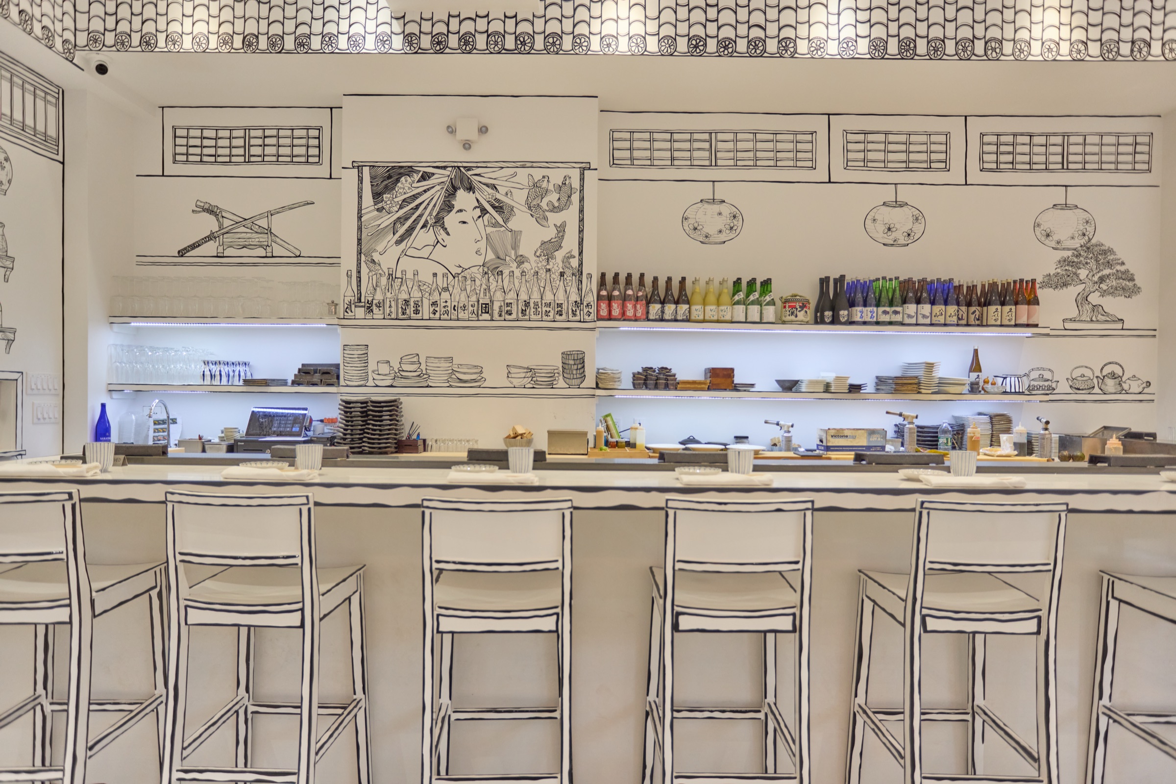 The Shirokuro dining room &mdash; banquette and counter, every line on the wall hand-drawn